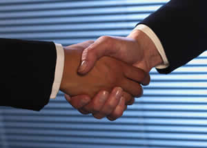 Two people shake hands.